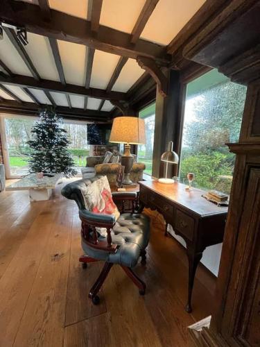 a living room with a desk and a chair at Brownhills in Eaton