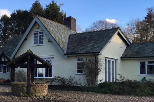 a white house with a black roof at Brownhills in Eaton