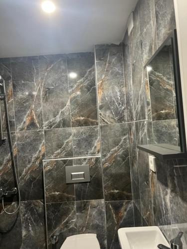 a bathroom with two sinks and a marble wall at Zerya suites in Istanbul