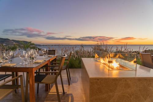 a dining room with a table and a fire pit at Hotel Indigo La Paz Puerta Cortes by IHG in La Paz