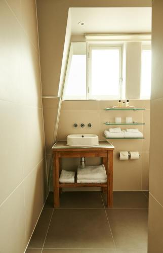 a bathroom with a sink and a mirror at The Bull and The Hide in London