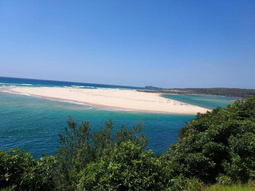 a view of a beach in the ocean at Bondi Breeze @ Tuross Head in Tuross Heads