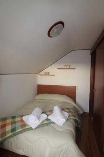 1 dormitorio con 1 cama con 2 toallas en Appartamento Monique, en Pieve di Soligo