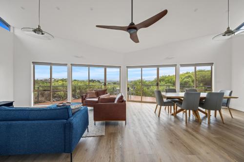 a living room with a blue couch and a table at Beach Escape Penthouse 2 Bdr Apartment in Sandy Point