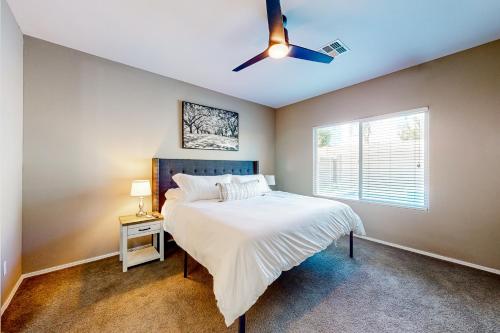 a bedroom with a bed and a ceiling fan at Sweet Home Sherman in Goodyear