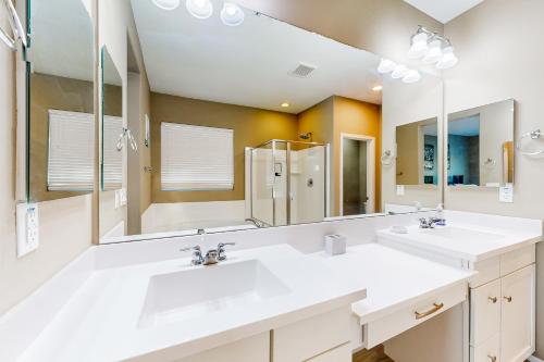 a bathroom with two sinks and a large mirror at Sweet Home Sherman in Goodyear