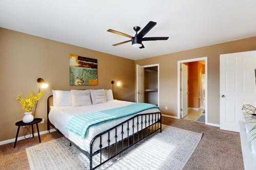 a bedroom with a bed with a ceiling fan at Time for Tempe in Tempe