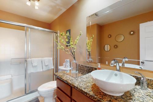 a bathroom with a sink and a toilet and a shower at Time for Tempe in Tempe