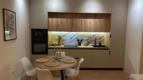 a kitchen with a table and chairs in a room at Gjirokastra Design Apartments in Gjirokastër