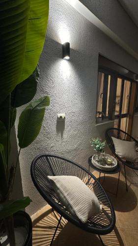 a room with a chair with a pillow and a mirror at Gjirokastra Design Apartments in Gjirokastër