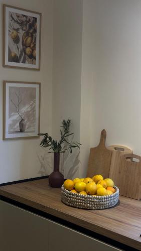 a bowl of lemons sitting on a table at Gjirokastra Design Apartments in Gjirokastër
