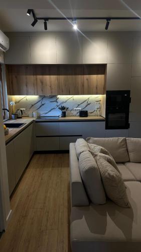 a living room with a couch and a kitchen at Gjirokastra Design Apartments in Gjirokastër