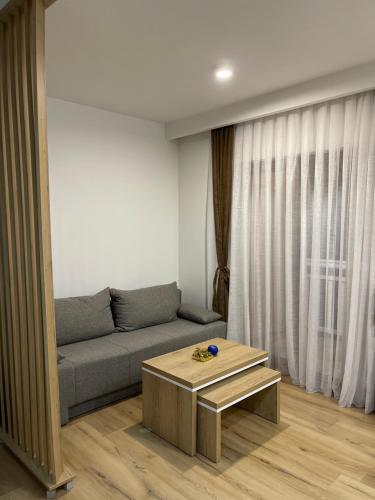 a living room with a couch and a coffee table at Honey Valley Bjelašnica in Bjelašnica