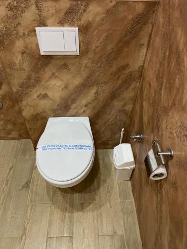 a bathroom with a white toilet and a sink at Honey Valley Bjelašnica in Bjelašnica