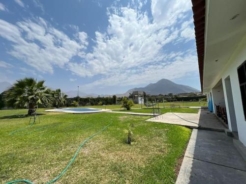 a yard with a hose on the grass at Casa de Campo en Conache in Trujillo