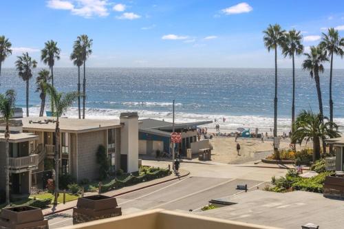 a view of a beach with palm trees and the ocean at Brooks Beach Vacations House B222 Oceanside in Oceanside