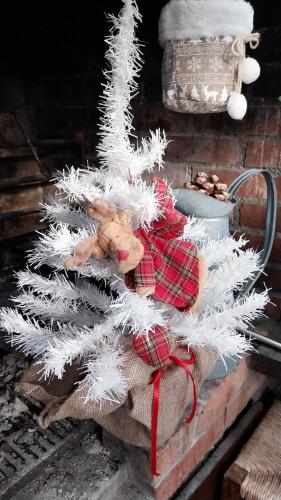 a white christmas tree with a teddy bear under it at VILLA VILLACOLLE in Procchio