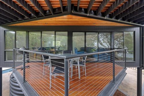 a screened in porch with a table in a house at Sandy Point Beach Escape 2 Bedroom Apartment in Sandy Point