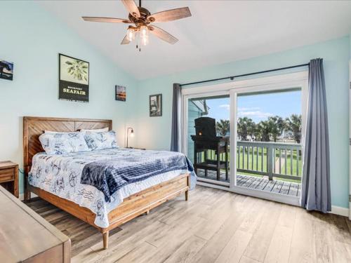 a bedroom with a bed and a large sliding glass door at Bayfront Kontiki 704 in Rockport
