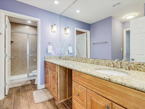 a bathroom with a large sink and a shower at Bayfront Kontiki 704 in Rockport