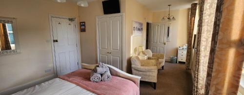 a bedroom with a bed with a pink blanket at Ferndene Guest House in Keswick