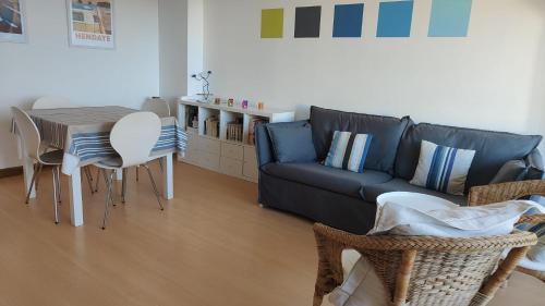 un salon avec un canapé, une table et des chaises dans l'établissement Appartement 3 pièces au coeur d'Hendaye plage, à Hendaye