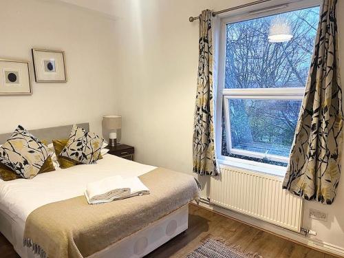 a bedroom with a bed and a window at Yeovil Apartments in Yeovil
