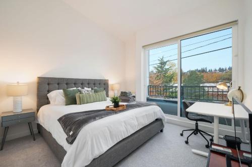 a bedroom with a bed and a large window at Sand Point Haven BY Betterstay in Seattle