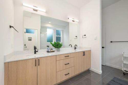 a bathroom with a sink and a large mirror at Sand Point Haven BY Betterstay in Seattle
