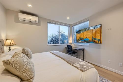 a bedroom with a bed and a large window at Wallingford Comfort BY Betterstay in Seattle