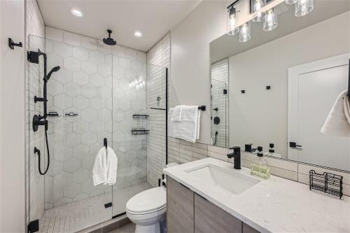 a bathroom with a toilet and a sink and a shower at Wallingford Comfort BY Betterstay in Seattle