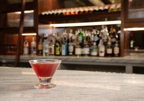 a drink in a glass sitting on top of a table at Hotel Indigo Baltimore Downtown by IHG in Baltimore
