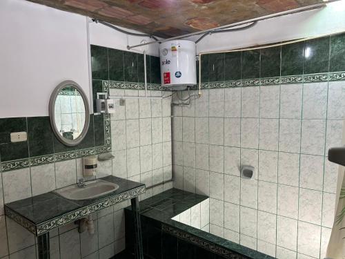 a bathroom with a sink and a mirror at Hospedaje de la Abuela in Salinas
