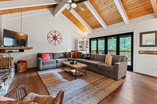 a living room with a couch and a table at Trailblazer Chalet at Olympic Valley with Private Hot Tub and Ski Shuttle in Alpine Meadows