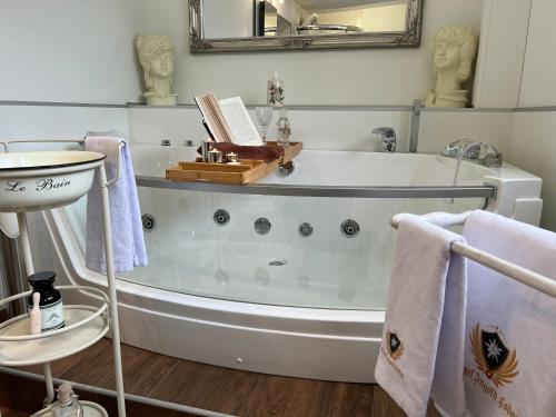 a bathroom with a bath tub with a book on it at Engel Ingold Lodge Chalet "Bärgblümli" in Habkern