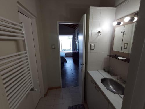 a bathroom with a sink and a mirror at La Laguna - Casa familiar a 5 cuadras de la playa. in Puerto Madryn