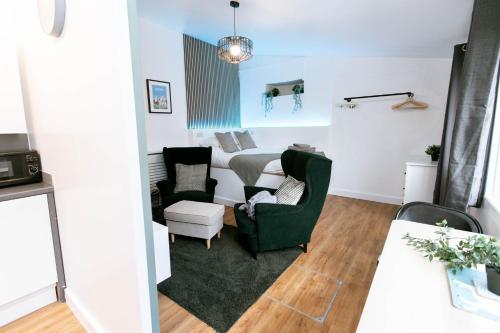 a living room with two chairs and a couch at Smart Modern Studio With Free Parking, Wifi, Close To Town, Hospital, Uni, Quiet Area, Contact For Best Prices in Exeter