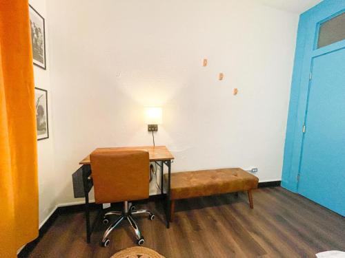 a room with a desk and a chair and a lamp at ITH San Diego Mission Beach Backpacker Hostel in San Diego