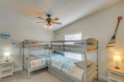 two bunk beds in a room with a ceiling fan at Modern Bloomington Home about 10 Mi to Bear Lake! in Bloomington
