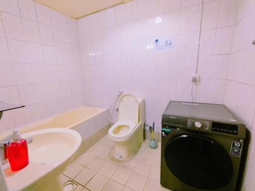 a small bathroom with a toilet and a sink at Star Capsule Hostel Near Burjuman Metro Station in Dubai