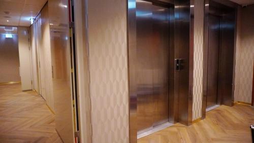 an elevator in a building with a wooden floor at Hotel Fogo Amsterdam in Amsterdam