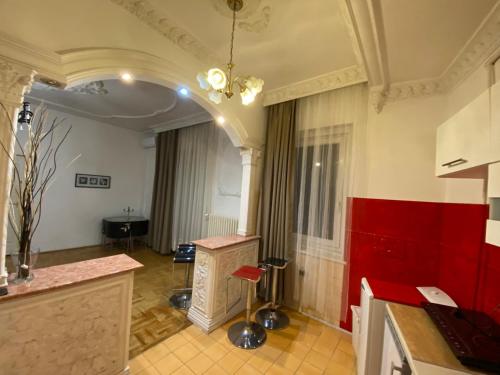 a room with a table and a red wall at Apartment with Balcony and AC next to Danube in Budapest
