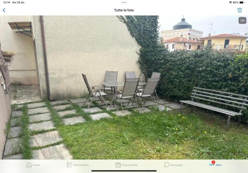 a patio with chairs and a table and a bench at Casa M&N in Thiene