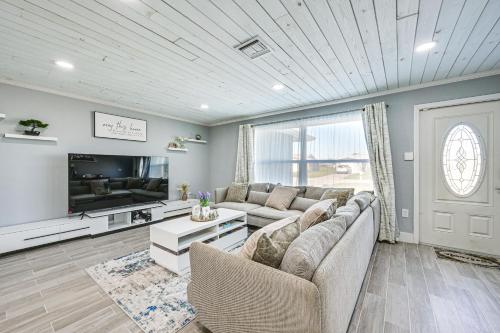 a living room with a couch and a tv at Florida Gulf Coast Getaway Pool and Screened Lanai! in Rotonda West