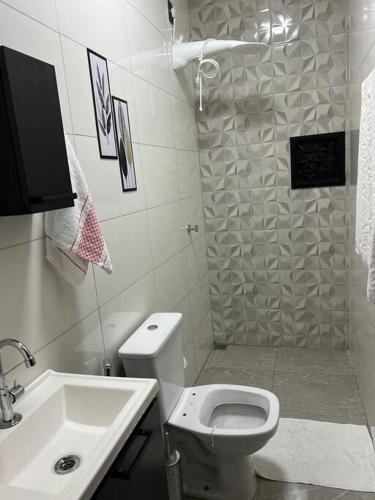 a bathroom with a shower and a toilet and a sink at Kitnet Cidade de Goiás - Go #02 in Goiás