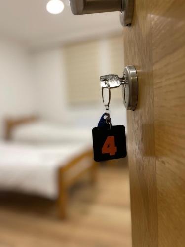 a door key with a number four on it at Honey Valley Bjelašnica in Bjelašnica