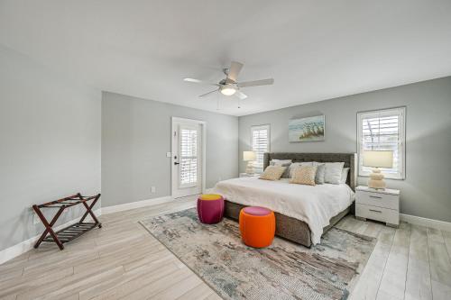 a white bedroom with a bed and a ceiling fan at Central Naples Home with Private Pool, Spa and Lanai! in Naples