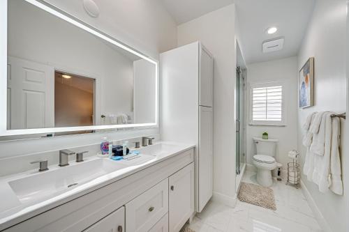 a white bathroom with a sink and a toilet at Central Naples Home with Private Pool, Spa and Lanai! in Naples