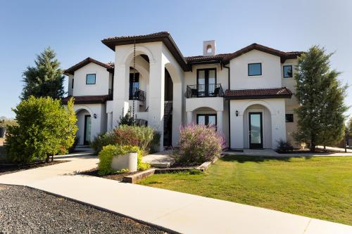 a large white house with a driveway at Barons Creek Vineyards in Fredericksburg
