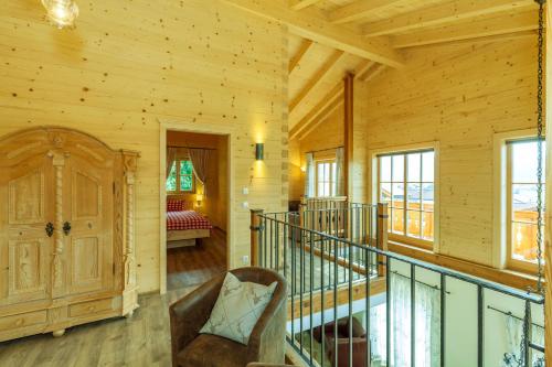 a room with a staircase in a log cabin at Chalet unter weiß-blauem Himmel in Reit im Winkl